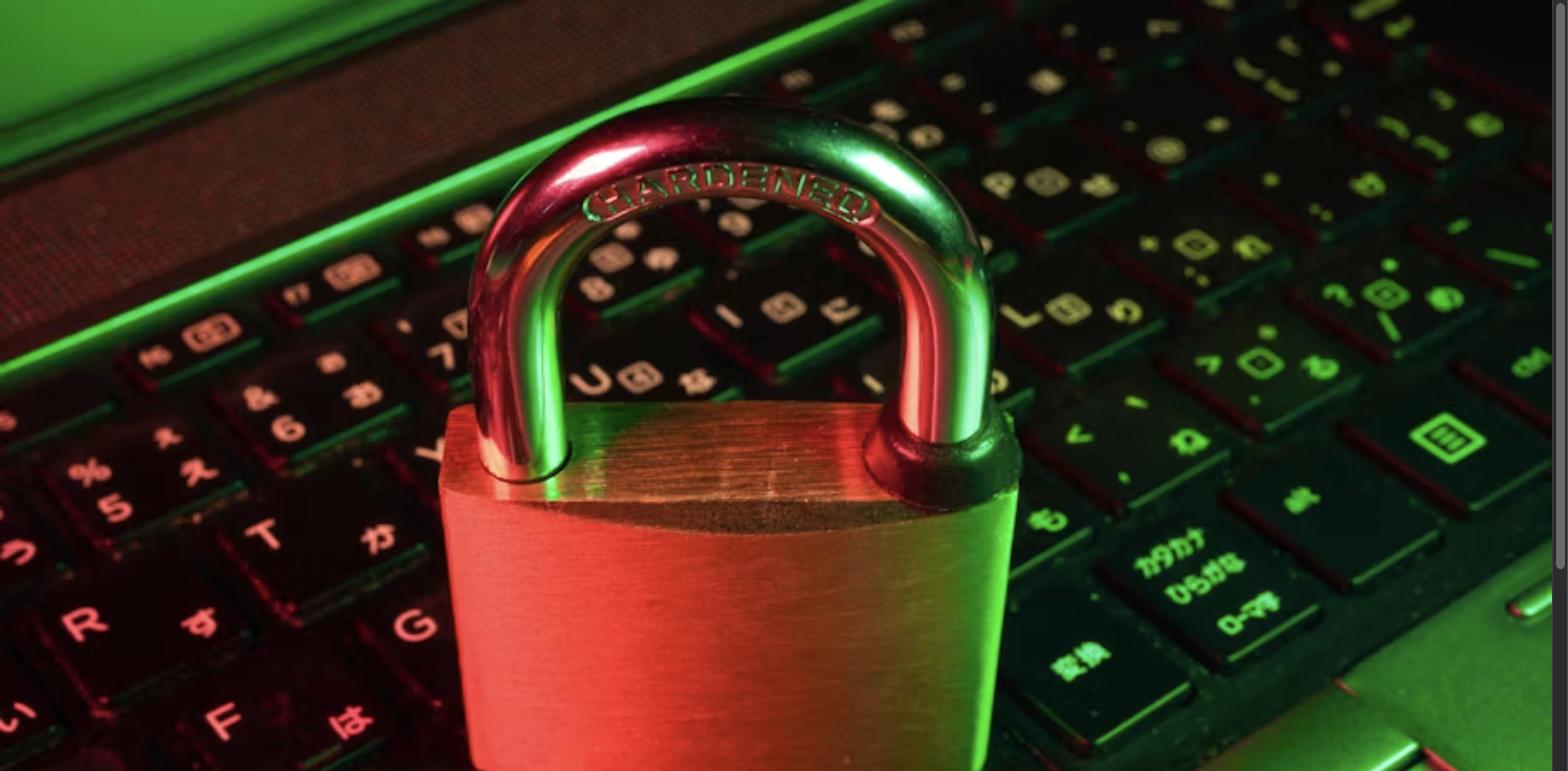 Red padlock resting on a computer keyboard, representing AI-driven fraud detection and cybersecurity in real estate transactions