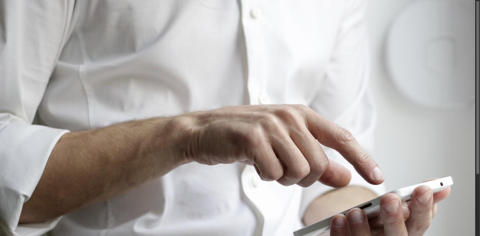 Close-up of a person's hand using a smartphone, representing AI-powered property search and personalized listing recommendations